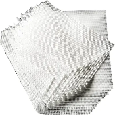 A stack of white silicone dehydrator sheets.