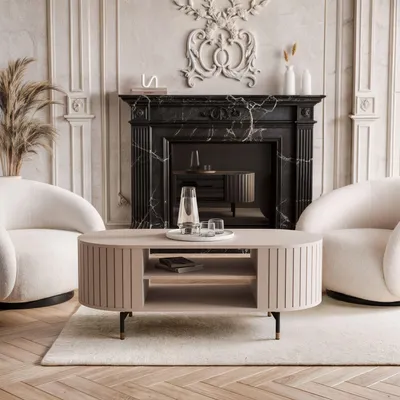 A luxurious living room scene featuring a coffee table in front of a fireplace, with two armchairs on either side.