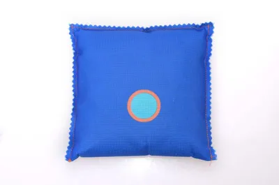 A blue dehumidifier bag with a teal and orange circle in the center, placed on a white background.