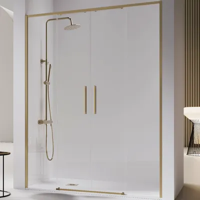 A modern shower enclosure with gold accents and a shower fixture.