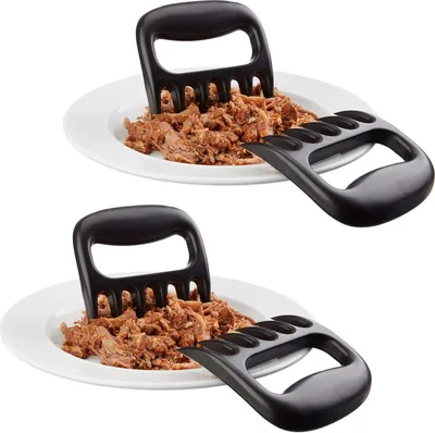 Two plates of shredded meat, each with a black meat claw inserted.