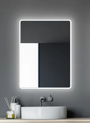 A modern bathroom vanity with a sink and a lighted mirror above it.