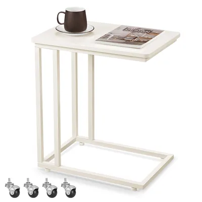 A C-shaped side table with a mug and a magazine.