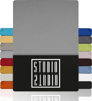 A stack of fabric swatches in various colors, with a large gray swatch dominating the center, and a black panel at the bottom featuring a white logo.