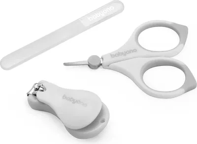 A set of baby nail care tools including nail clippers, scissors, and a nail file, arranged on a white background.