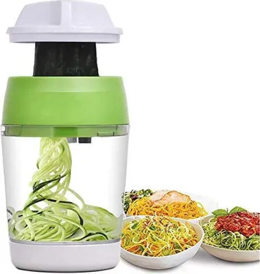 A vegetable spiralizer with zucchini noodles inside, next to three bowls of pasta.