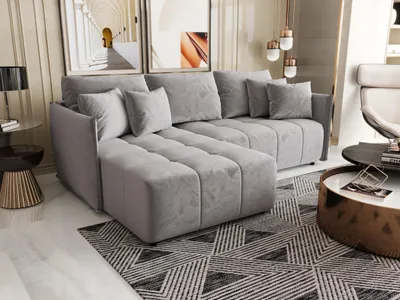 A modern living room setting with a grey sectional sofa as the main focus.
