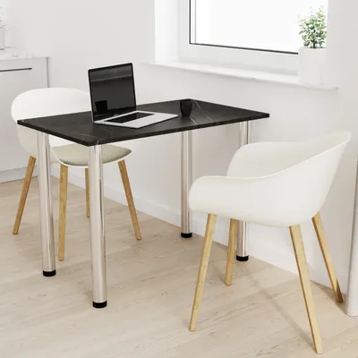 A small dining table with two chairs in a bright, modern room.