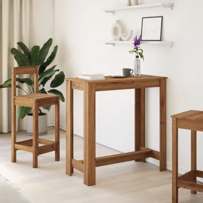 A bar table and stool set in a room with a plant and shelves.