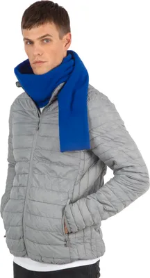 A man wearing a grey puffer jacket and a blue scarf.
