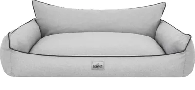 A light gray dog bed with black trim and a small logo on the front.