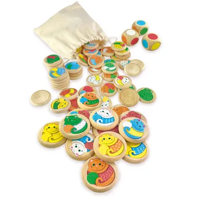A collection of wooden game pieces and dice are scattered on a white surface, with a drawstring bag in the background.