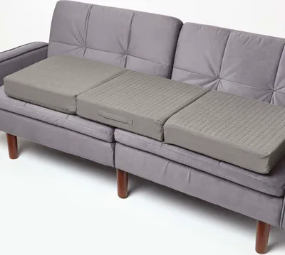 Three gray sofa cushions are placed on a gray sofa.
