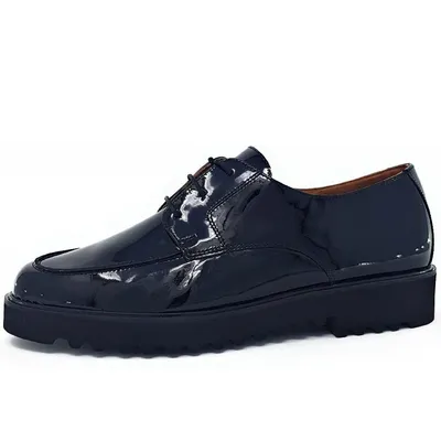 A side view of a black patent leather shoe with a thick sole.