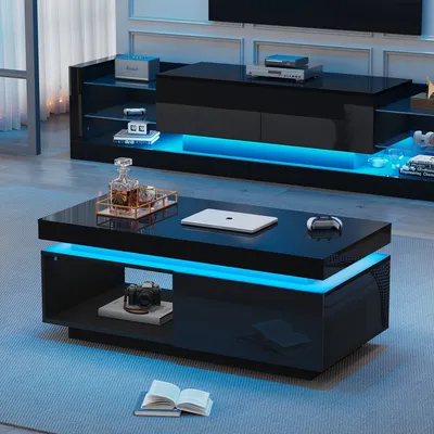 A modern living room with a black high-gloss coffee table and entertainment center, both illuminated with blue LED lights.