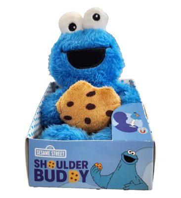 A plush toy of Cookie Monster from Sesame Street, holding a cookie, inside its retail packaging.