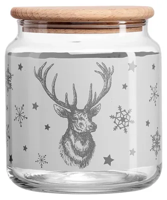 A glass jar with a wooden lid, decorated with a winter-themed design featuring a stag and snowflakes.