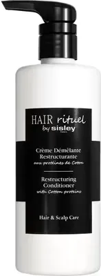 A white bottle of hair conditioner with a black pump dispenser, set against a white background.