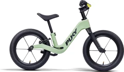 A light green balance bike with black wheels and seat is shown against a white background.