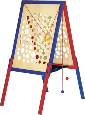 A wooden climbing frame with red and blue supports, featuring a grid of holes and hanging balls.
