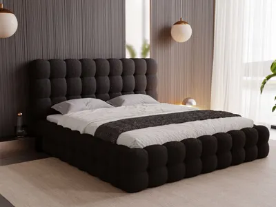 A modern bedroom with a dark upholstered bed.