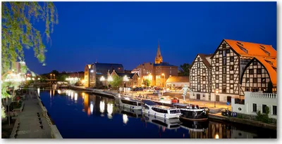 Produktbild von Tulup® Glas-Bild - 100x50 -Wandkunst - Wandbild hinter gehärtetem Sicherheitsglas  - Sehenswürdigkeiten & Architektur - Bromberg bei Nacht - Blau