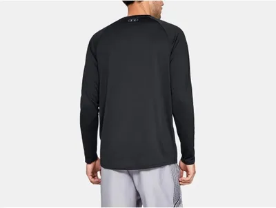 A man wearing a black long-sleeved shirt and grey shorts, viewed from the back.