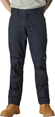 A person wearing dark navy blue Dickies pants and brown boots, shown from the waist down against a white background.