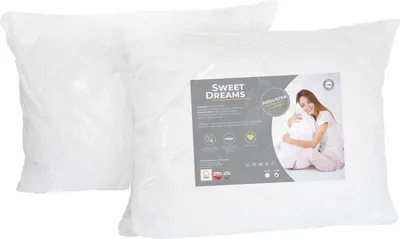 Two white pillows are shown, one in front of the other. The front pillow has a label with product information and an image of a woman.