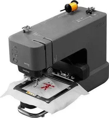 A close-up, studio shot of a Brother embroidery machine with a spool of yellow thread on top.