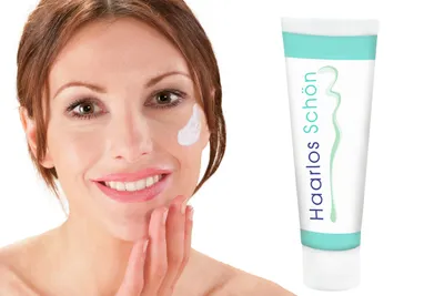 A woman is applying cream to her face next to a tube of the product.