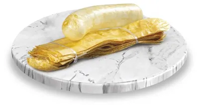 A bundle of dried pig casings on a marble-like plate.