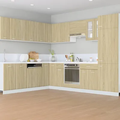 A modern kitchen with light wood cabinets and white countertops.