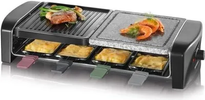 A raclette grill with food cooking on both the grill plate and the stone plate, with individual raclette pans below.