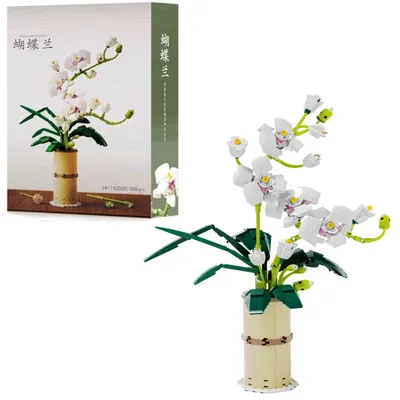 A building block model of white orchids in a vase, with the product packaging shown on the left.