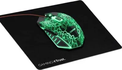 A gaming mouse with green lighting is placed on a black mousepad.