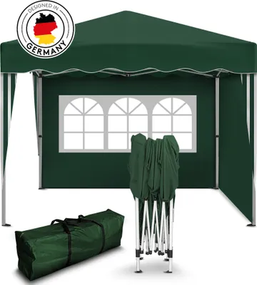 A green pop-up tent is shown, partially assembled, with a carrying bag and folded frame on a white background. The tent has arched windows and a German design logo.