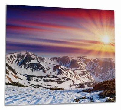 Produktbild von Wallario Herdabdeckplatte aus Glas, Größe 60 x 52 cm 1-teilig, Motiv Farbenfroher Sonnenuntergang im Winter - Schnee in den Bergen