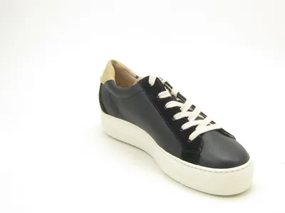 A single black leather sneaker with white laces and a tan heel accent is shown against a white background.