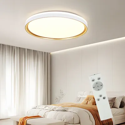 A modern bedroom with a ceiling light and a bed.