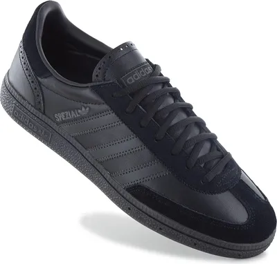A single black Adidas sneaker is shown from a diagonal angle against a white background.