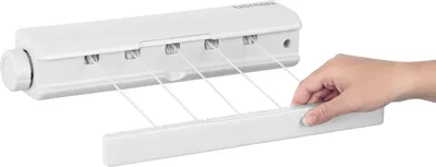 A hand is shown pulling out one of the retractable clotheslines from a wall-mounted drying rack.