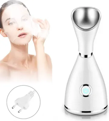 A woman applying a facial mask next to a facial steamer and a power plug.