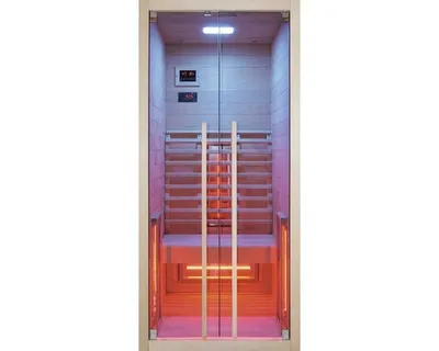 An infrared sauna cabin with glass doors, illuminated by colored lights.