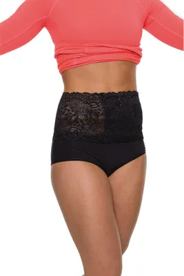 A person wearing a coral long-sleeved shirt and black underwear with a black lace band around their waist.