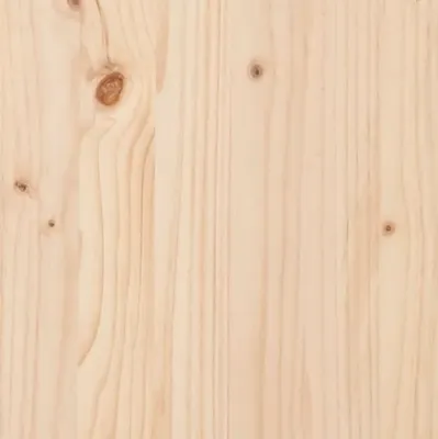 A close-up view of a wooden surface, likely a tabletop, showing the grain and knots of the wood.