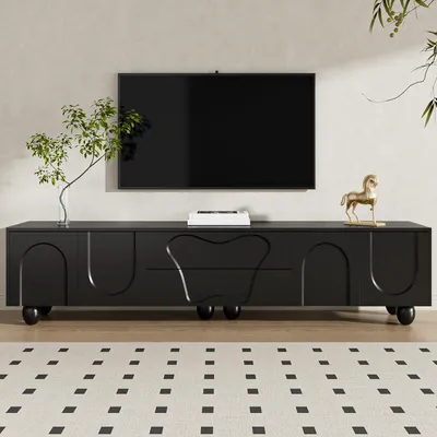 A black TV stand with a TV mounted above it in a modern living room setting.
