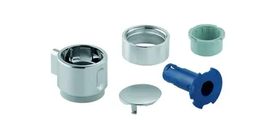 A collection of plumbing parts, including a chrome handle, a silver cap, a green plastic insert, and a blue plastic fitting, arranged on a white background.