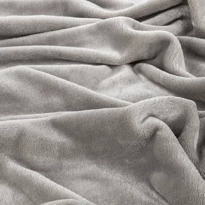 A close-up, textured view of a soft, gray blanket.