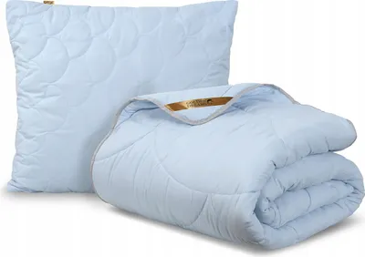 A light blue pillow and a folded comforter are displayed against a white background.